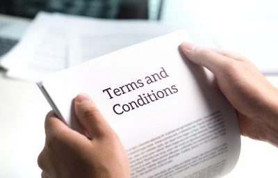 Terms and conditions text in legal agreement or document about s Terms and conditions text in legal agreement or document about service, insurance or loan policy. Lawyer or client holding contract paper in office.